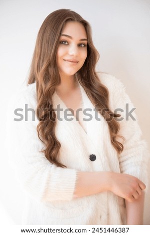 young woman with long brown hair and beautiful smile.