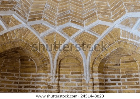 Brick arches with white accents inside historical bath (hammam) in Bukhara city. Warm lighting, perfect for historical themes. Bukhara (Buxoro), Uzbekistan