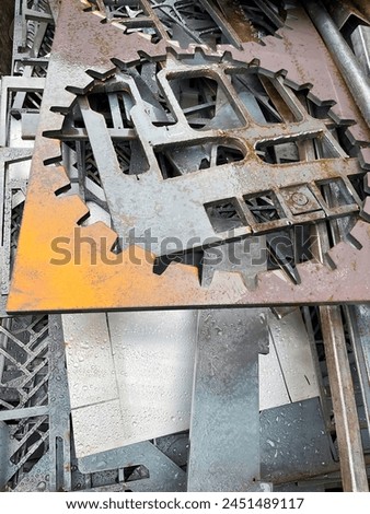 Laser cut steel sheets in the waste skip ready for recycling