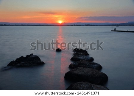 The sunset viewed from the Western coast of Ortigia Island, Syracuse, Sicily, Italy. Picture taken from Belvedere of Largo Aretusa