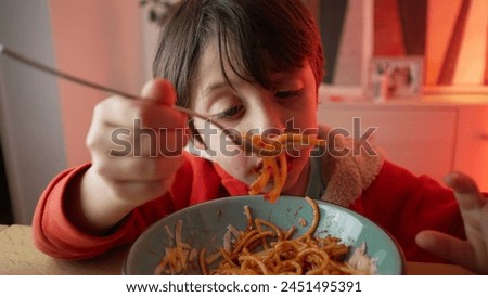 Young Child Delighting in Spaghetti Dinner, 5-Year-Old Boy's Meal Enjoyment, Close-Up of Happy Pasta Eating Experience 480p.m Royalty-Free Stock Photo #2451495391