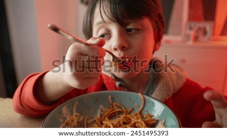 Young Child Delighting in Spaghetti Dinner, 5-Year-Old Boy's Meal Enjoyment, Close-Up of Happy Pasta Eating Experience 480p.m Royalty-Free Stock Photo #2451495393