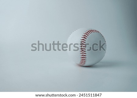 White and red colored baseball sport ball object photography isolated on horizontal white studio background from front angle.