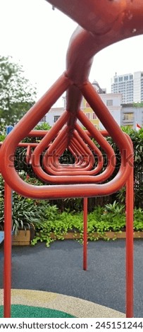 Triangular circular Monkey bar tic tac toe at school outdoor playground