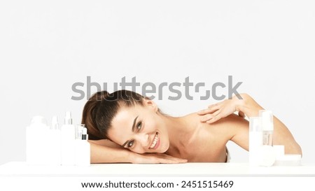 Gorgeous middle aged woman touching her perfect skin. Beautiful portrait of a 40-50 year old woman advertising anti-aging facial products, salon care, skin tightening, isolated on white background. Royalty-Free Stock Photo #2451515469