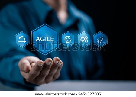 Agile development methodology concept, businessman holding agile icon on virtual screen for process that will help you work faster By reducing step-by-step work and focusing on team.