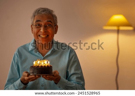 Sad senior man celebrating his birthday at home