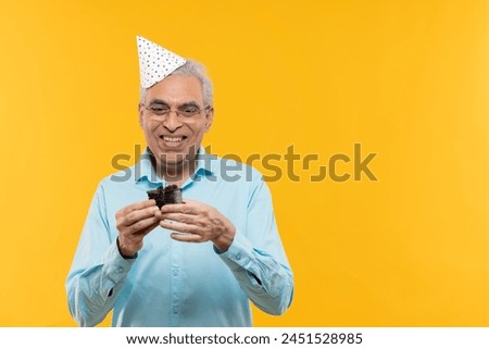 Portrait of senior man celebrating his birthday