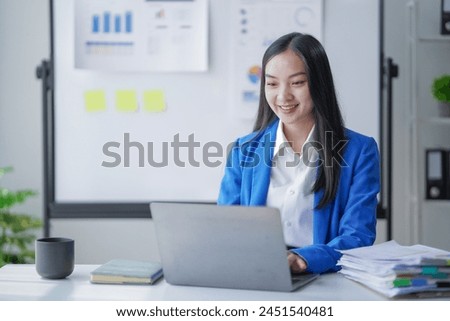 Beautiful Female  sitting at the Table Works on a Laptop. Stylish Woman in the Office 