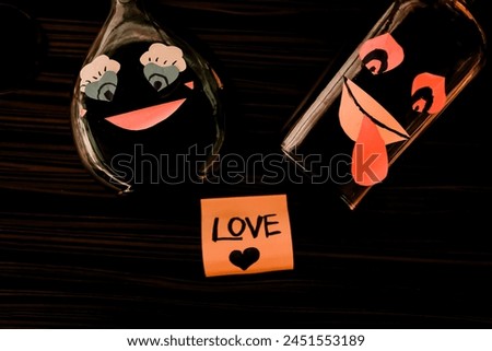 Conceptual Brown and green love wine bottles love each other. hand crafted smile cartoon on the bottle