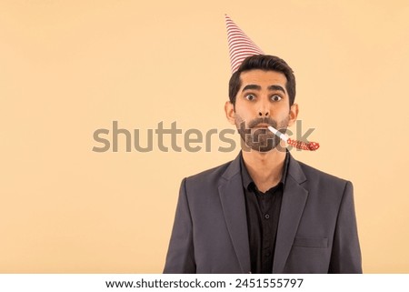 Happy business man in party hat blowing party horn