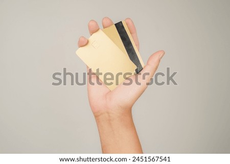 male hand holding gold Bank credit Card mockup template on isolated background