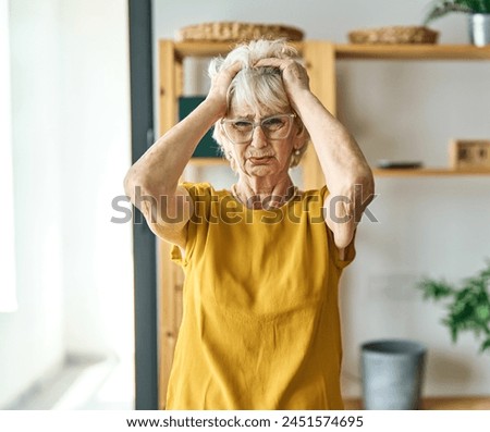 Portrait of a frustrated angry sad senior elderly woman at home Royalty-Free Stock Photo #2451574695