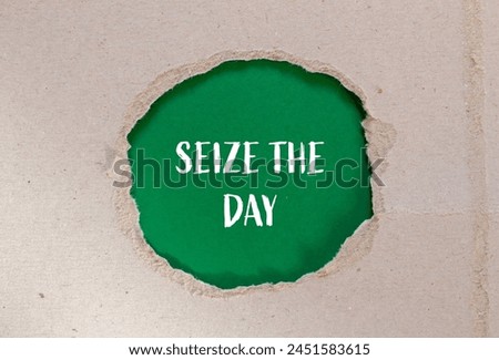 Seize the day words written on ripped paper with green background. Conceptual seize the day symbol. Copy space. Royalty-Free Stock Photo #2451583615