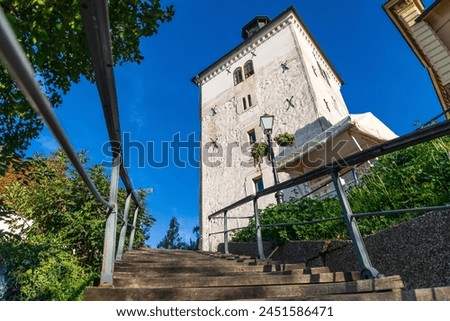 Staircase leading to the majestic Lotrščak Tower, a symbol of Zagreb's rich history, under a bright blue sky. Royalty-Free Stock Photo #2451586471