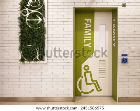 Entrance door of priority public toilet or public restoom for Family and people with Disablity with disabled sign at shopping center. Disabled toilet concept.