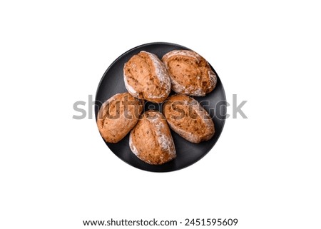 Fresh baked bread buns with salt, spices, seeds and grains on a dark background
