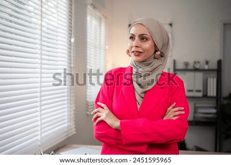 Confident Muslim businesswoman supervisor checks work on holiday and works in home office