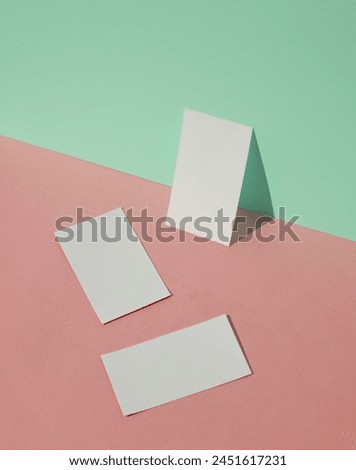 White blank business cards on a blue-pink pastel background. Creative minimal layout. Corporate identity