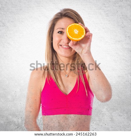 Sport woman holding an orange