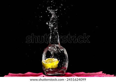 Closeup Image Of Falling Lime Into Clear Water. Splashing Water Outside, Dark Background