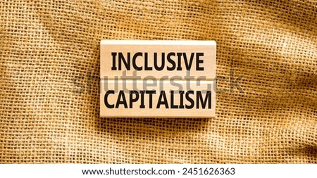 Inclusive capitalism symbol. Concept words Inclusive capitalism on beautiful wooden blocks. Beautiful canvas table canvas background. Business inclusive capitalism concept. Copy space