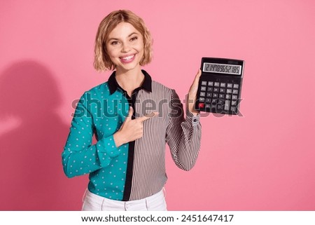 Photo portrait of pretty young girl hold point calculator financier wear trendy striped cyan outfit isolated on pink color background