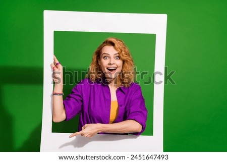 Photo portrait of lovely young lady instant photo frame excited reaction dressed stylish violet clothes isolated on green color background