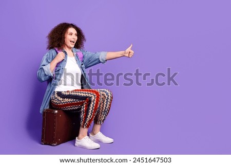 Full size photo of cool nice girl valise hitch hiking empty space wear denim shirt isolated on violet color background