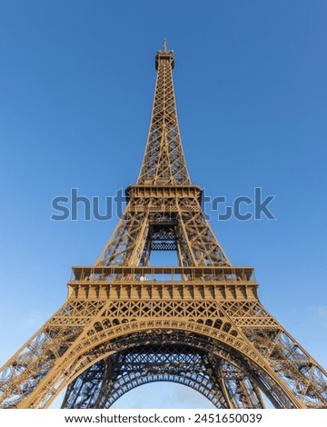Paris, the Eiffel Tower from below against a blue sky. tall perspective photograph Royalty-Free Stock Photo #2451650039