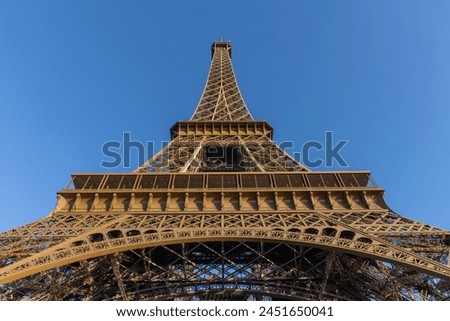 Paris, the Eiffel Tower from below against a blue sky. tall perspective photograph Royalty-Free Stock Photo #2451650041