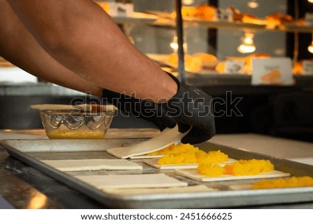 Volcanoes preparing pastes, puff pastry with ham, pineapple and cheese