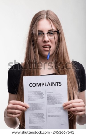 Analytical gaze fixed on complaints, she embodies resolve and scrutiny Royalty-Free Stock Photo #2451667641
