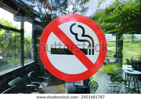 no smoking sign on the glass