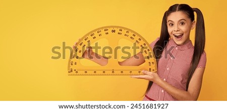 amazed kid hold school math tool protractor ruler on yellow background, education. Portrait of schoolgirl student, banner header. School child face isolated panorama background with copy space.
