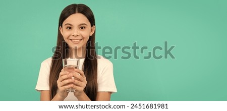 child feel thirsty. teen girl going to drink mineral beverage. healthy. Banner of child girl with glass of water, studio portrait with copy space. Royalty-Free Stock Photo #2451681981