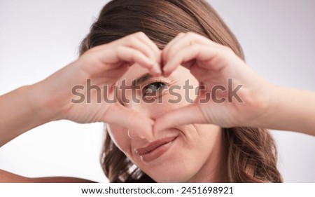 Woman, heart hands and sign for love in portrait, donation or charity with wellness and care on white background. Emoji, shape and romance gesture with thank you, feedback or reaction in studio