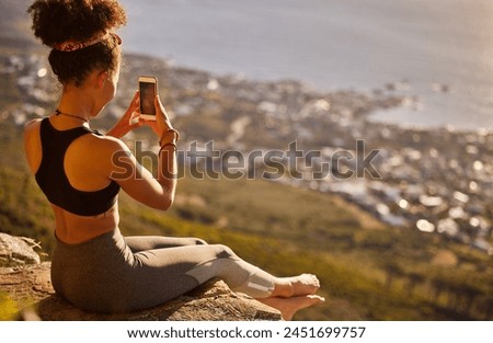 Mountain, fitness and phone for picture with woman to relax from exercise, training and workout of hiking. Healthy, female person and cliff for photography of scenic view with smartphone for memory