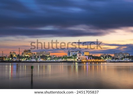 Bradenton, Florida, USA downtown cityscape on the Manatee River at dusk.