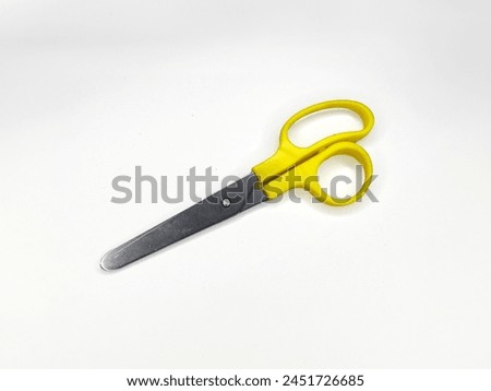 Picture of a yellow scissor in a isolated white background