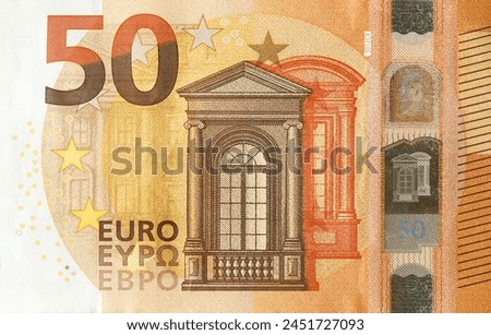 Fragment of one fifty euro money bill. Details of European union currency banknote of 50 euro close up