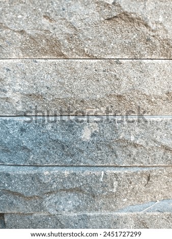 A stone wall can serve various purposes, from providing security and privacy to adding aesthetic appeal to a property. They can be built using different types of stones, such as fieldstone, granite Royalty-Free Stock Photo #2451727299