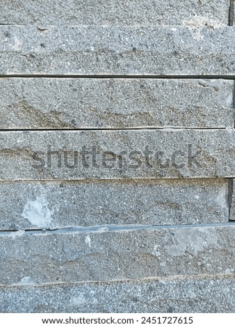A stone wall can serve various purposes, from providing security and privacy to adding aesthetic appeal to a property. They can be built using different types of stones, such as fieldstone, granite Royalty-Free Stock Photo #2451727615