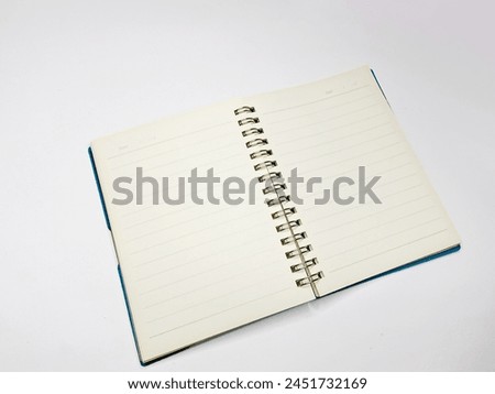 Picture image of an opened spiral note book with stripes and white paper in a plain white isolated backround