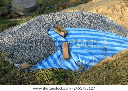 Pile of gravel or stone and sand in construction site.
Pile of fine sand for building the house Industrial object photo, close-up and selective focus.