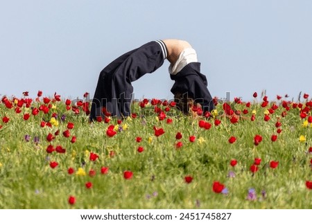 A girl makes a cartoon in a tulip field.