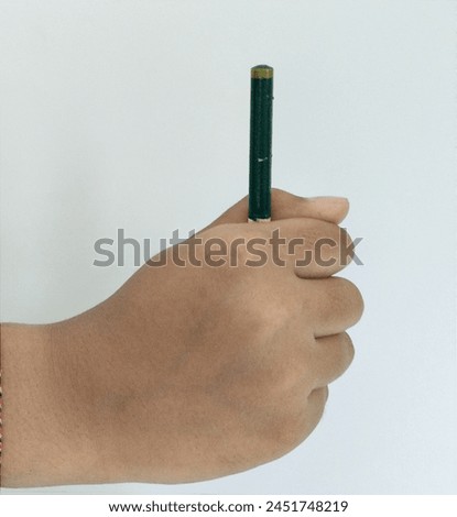hand holding a pencil as a picture of a child who is actively studying