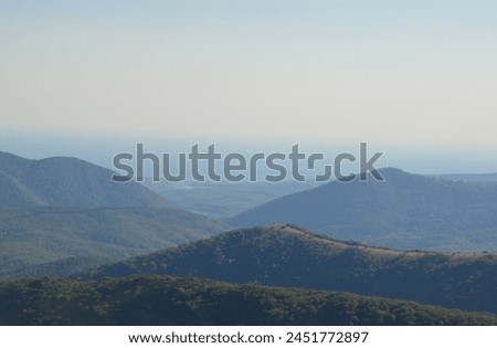 Beautiful mountain foggy landscape. Caucasus Mountains. Panoramic photo. Design for background, cover, screensaver, postcard, calendar.