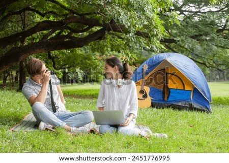 Couple taking pictures and camping in the garden