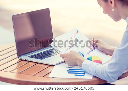 woman investment consultant analyzing company annual financial report balance sheet statement working with documents graphs. Stock market, office, tax, education concept. Hands with charts papers Royalty-Free Stock Photo #245178505